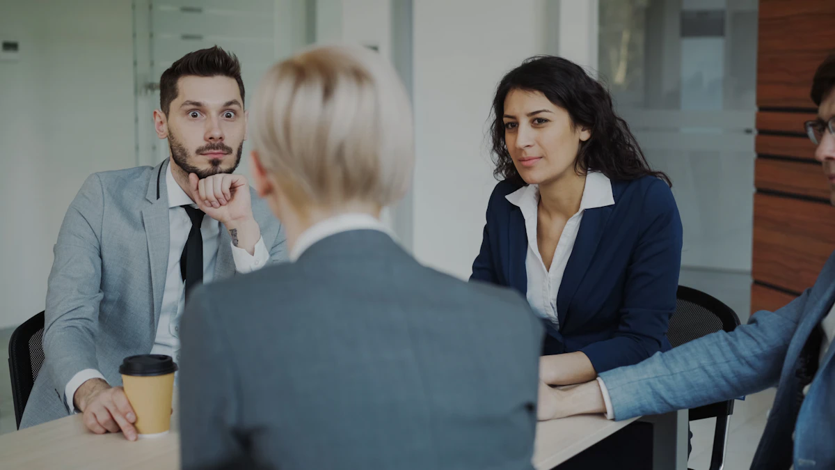 Colleagues discussing work around a table in an office.